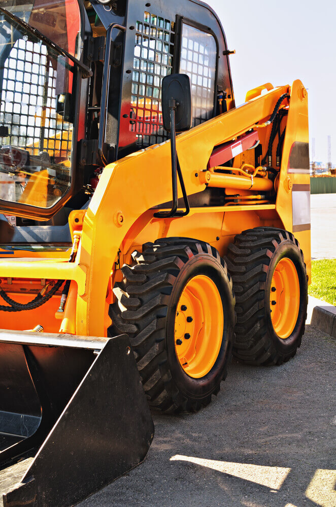 landscaping Ballarat's brand new yellow skid steer sitting in a carpark ready for some landscaping work